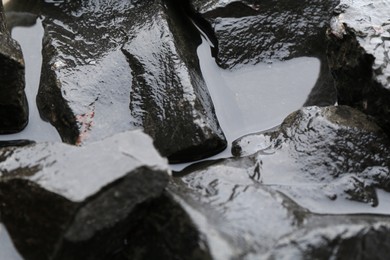 Beautiful pebbles in water as background, closeup