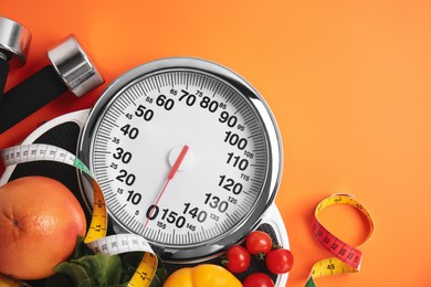 Photo of Flat lay composition with scales and healthy food on orange background, space for text
