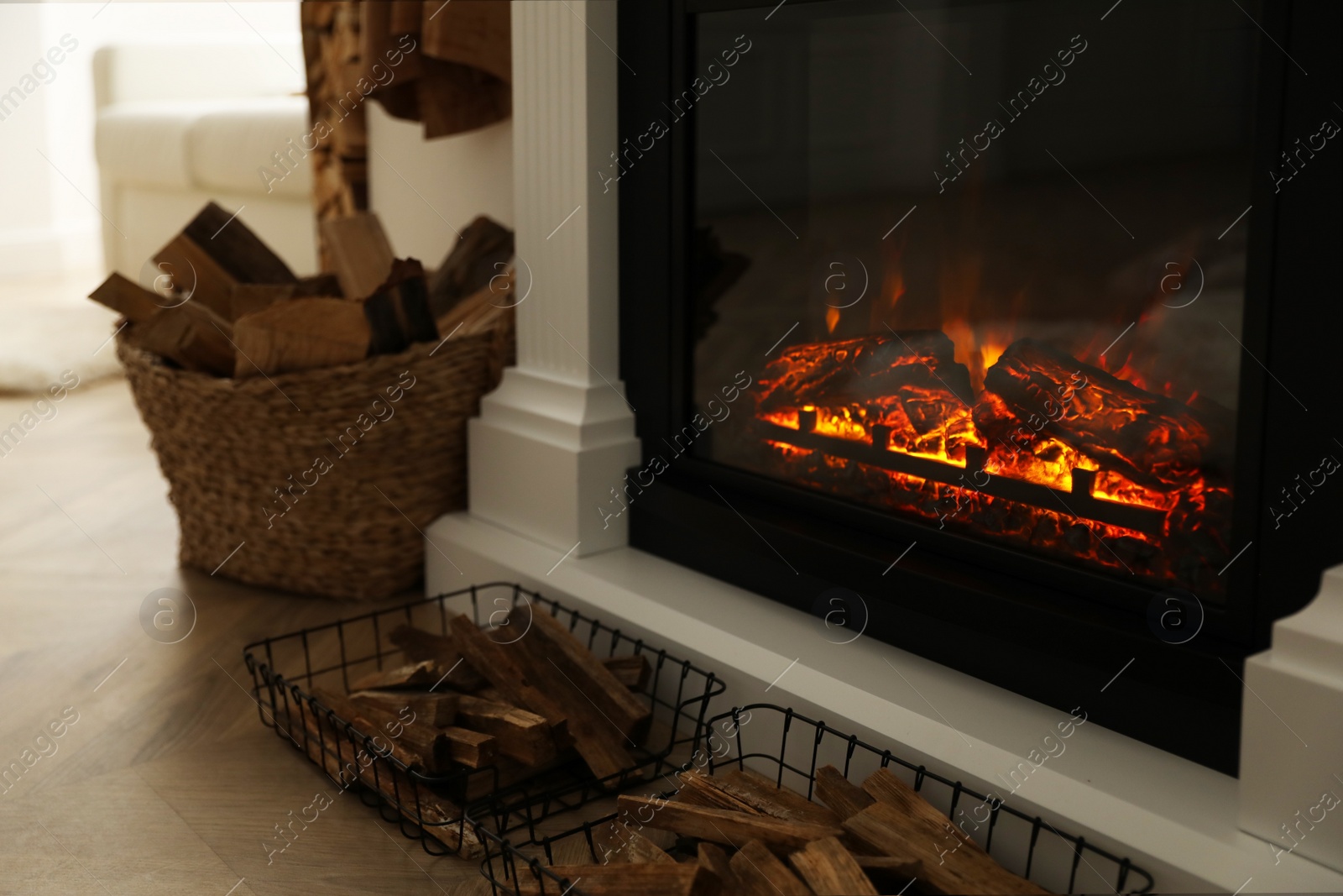 Photo of Firewood burning bright in elegant hearth indoors