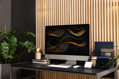 Photo of Cozy workspace with computer on metal desk at home