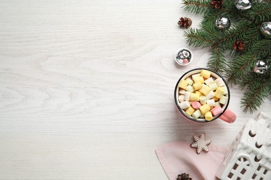 Photo of Delicious hot chocolate with marshmallows and Christmas decor on white wooden table, flat lay. Space for text