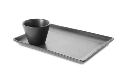 Photo of New black sauce dish and serving plate on white background