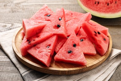 Photo of Delicious fresh watermelon slices on wooden table