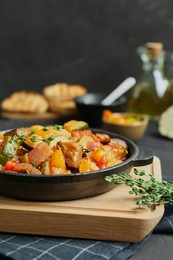 Photo of Dish with tasty ratatouille on black table, closeup