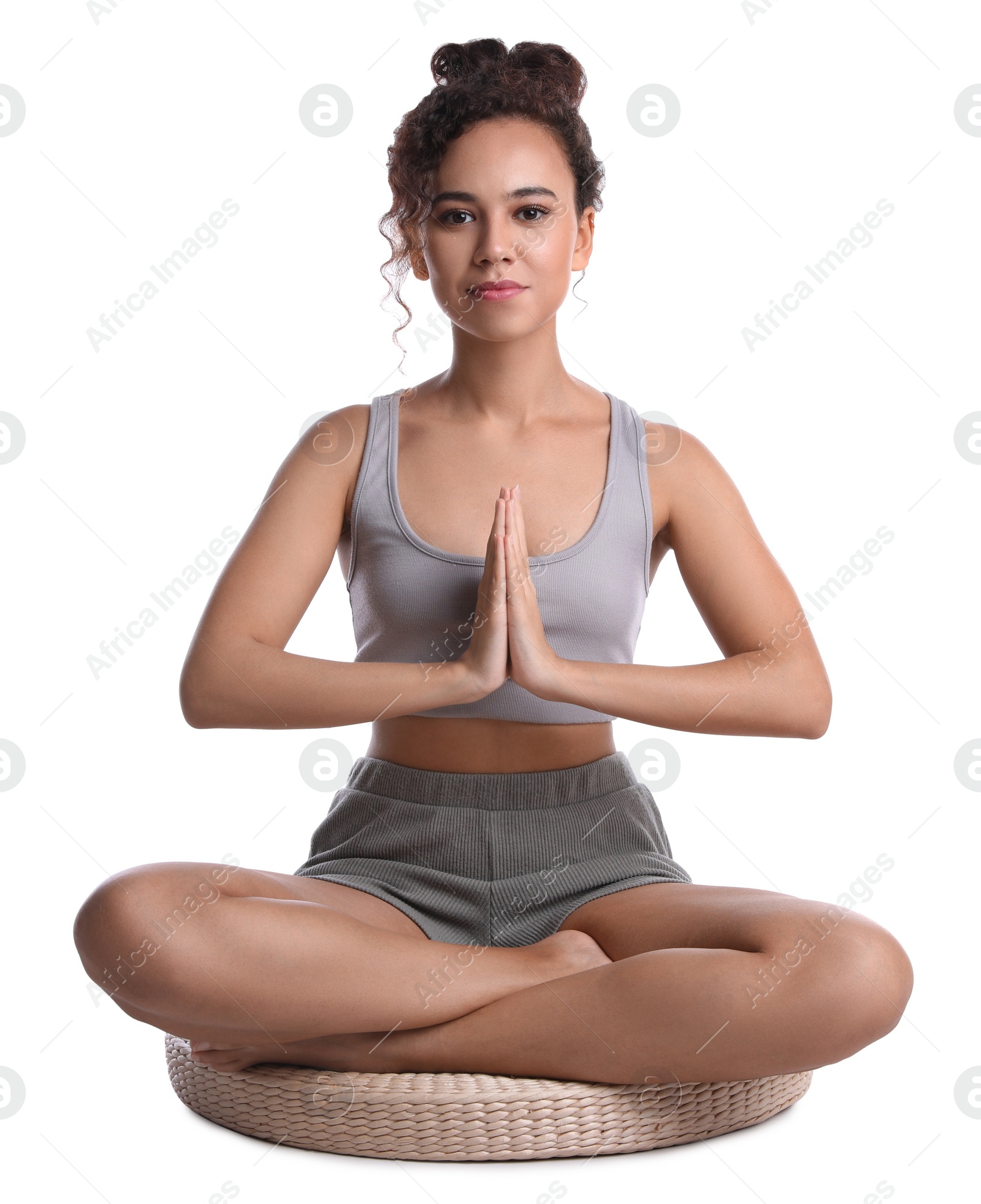 Photo of Beautiful African-American woman meditating on white background