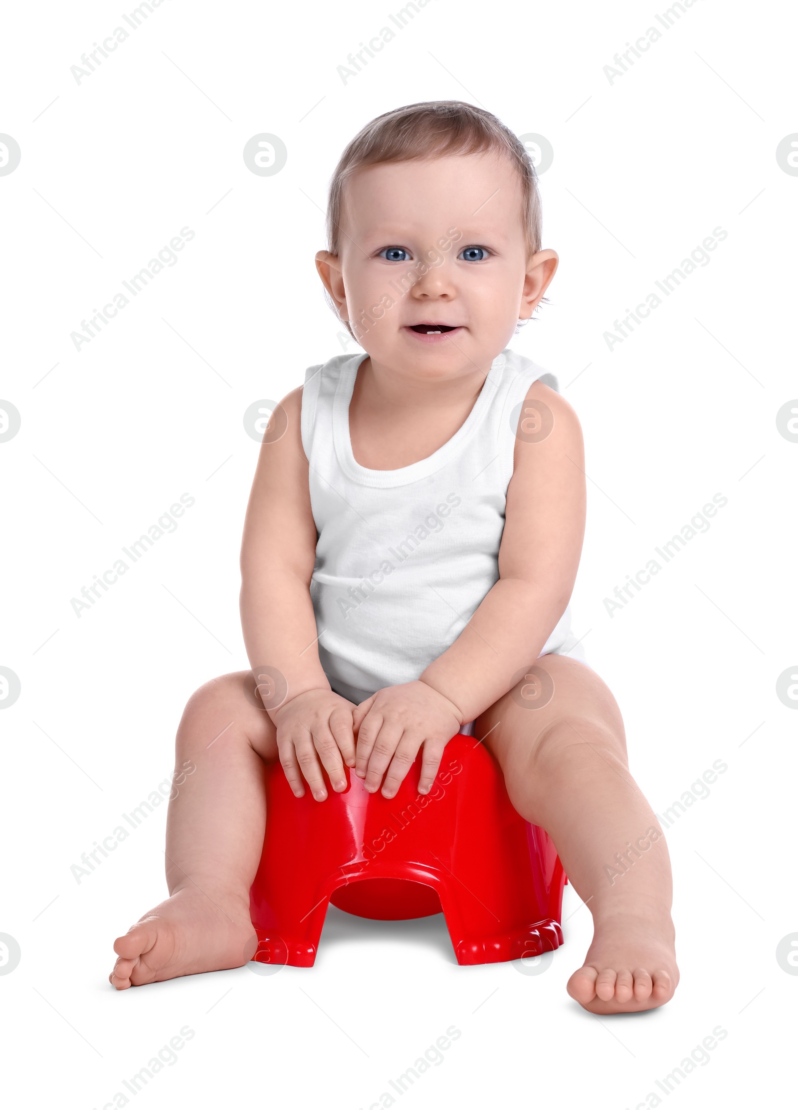 Photo of Little child sitting on baby potty against white background