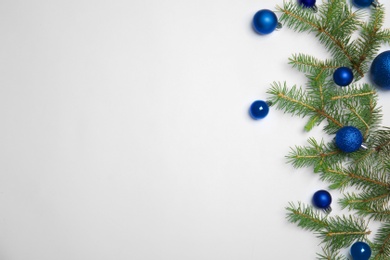 Photo of Composition with Christmas tree branches and festive decor on white background