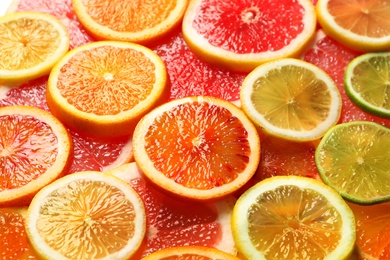 Photo of Slices of fresh citrus fruits as background