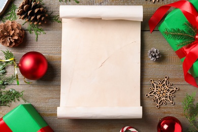 Flat lay composition with empty card and Christmas decorations on wooden table, space for text. Writing letter to Santa Claus