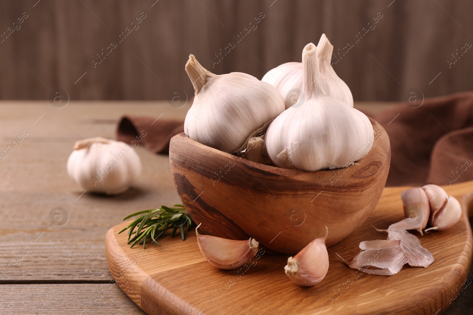 Photo of Fresh garlic on wooden table, closeup. Space for text