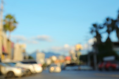 Blurred view of cityscape with cars on road. Bokeh effect