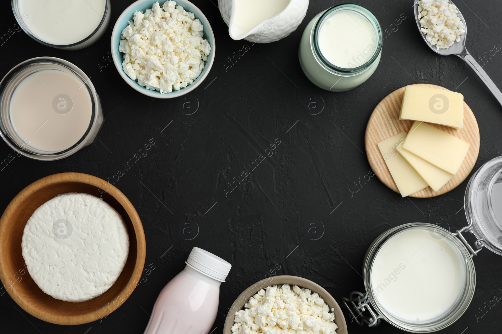 Photo of Frame made of lactose free dairy products on black textured table, flat lay. Space for text