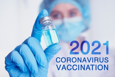 Doctor holding vial with coronavirus vaccine, closeup