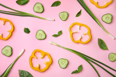 Photo of Flat lay composition with fresh ingredients for salad on pink background