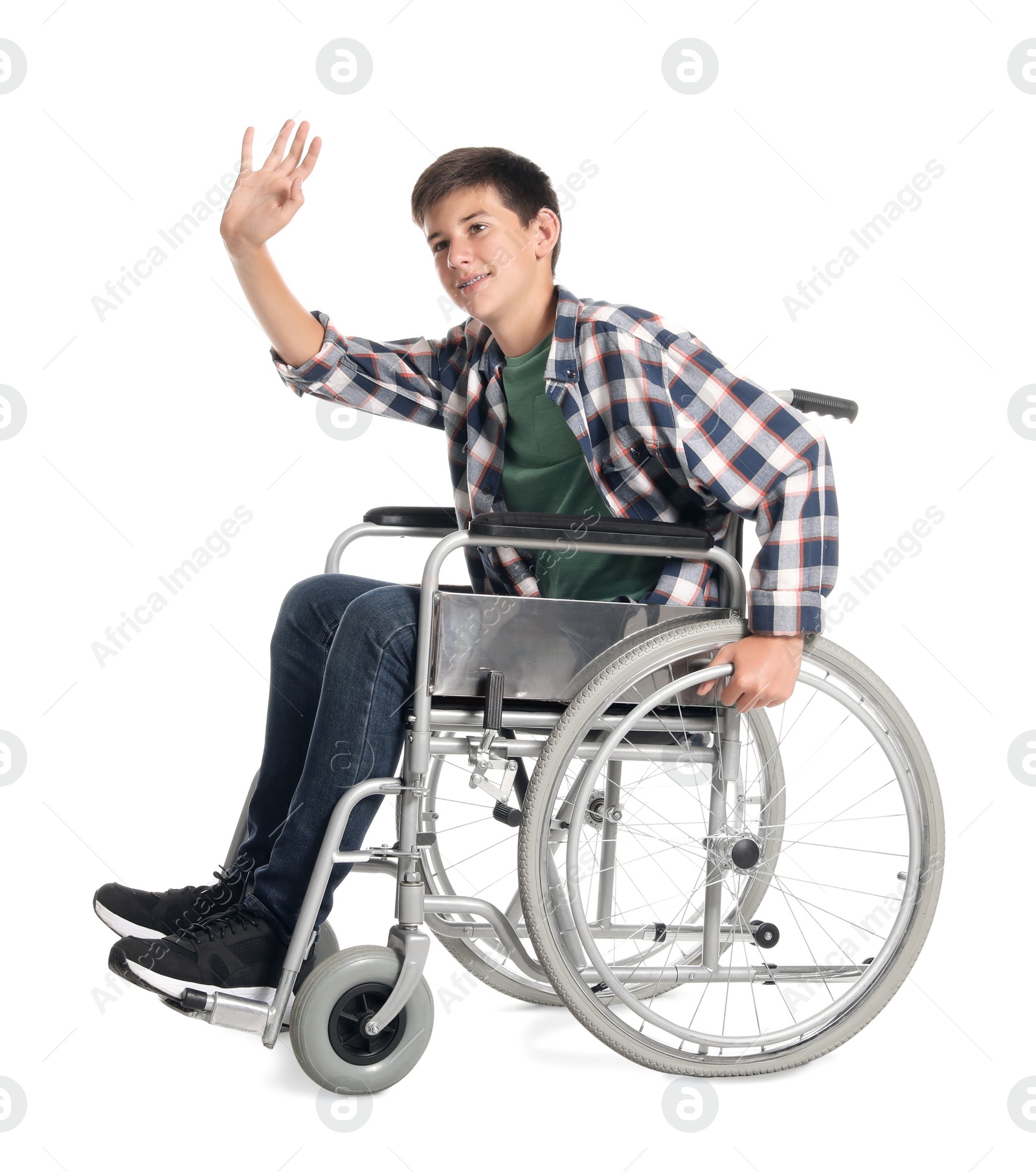 Photo of Teenage boy in wheelchair on white background