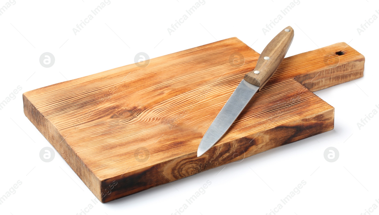 Photo of Utility knife and wooden board isolated on white