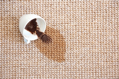 Photo of Spilled coffee on carpet, top view