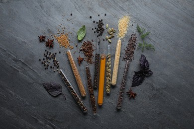 Photo of Flat lay composition with different spices and herbs on black slate table