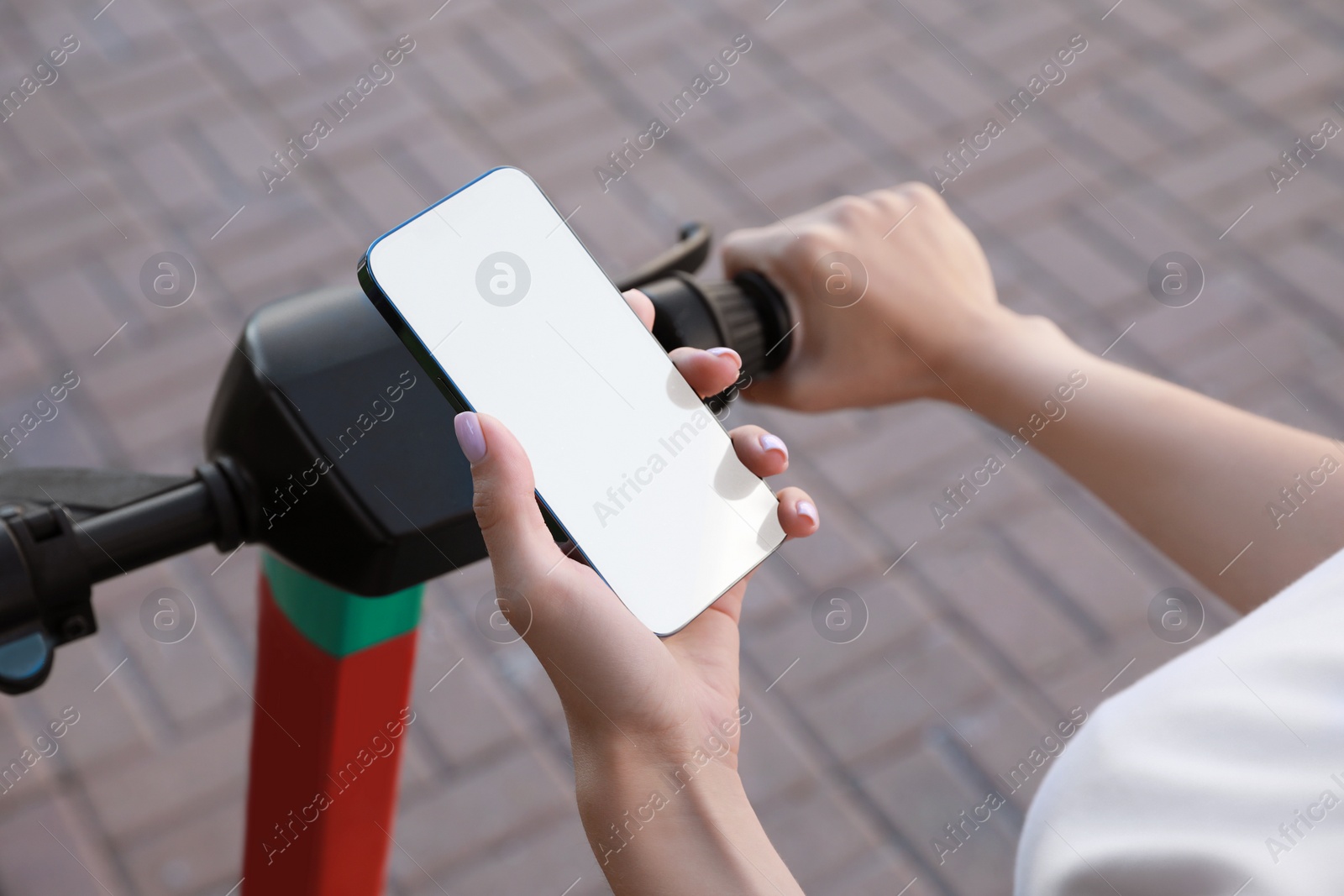 Photo of Woman using smartphone to pay and unblock electric kick scooter outdoors, closeup