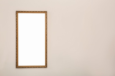 Photo of Frame with empty canvas on wall in modern art gallery. Mockup for design