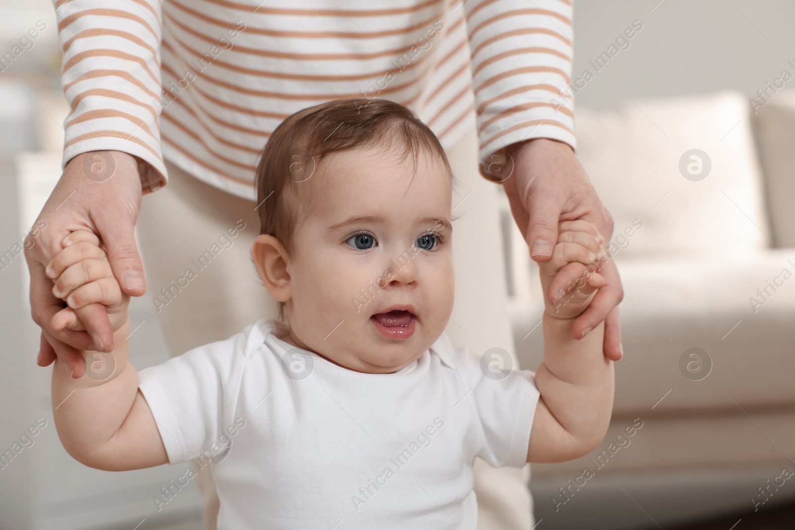 Photo of Mother with her cute baby at home, closeup