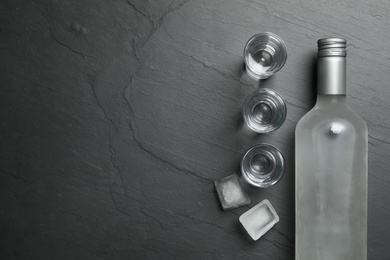 Photo of Cold Russian vodka on black table, flat lay. Space for text