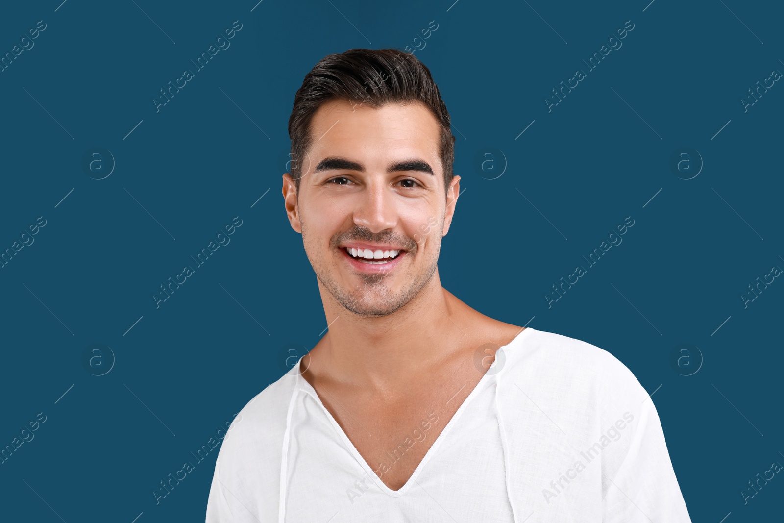 Photo of Portrait of handsome young man on blue background