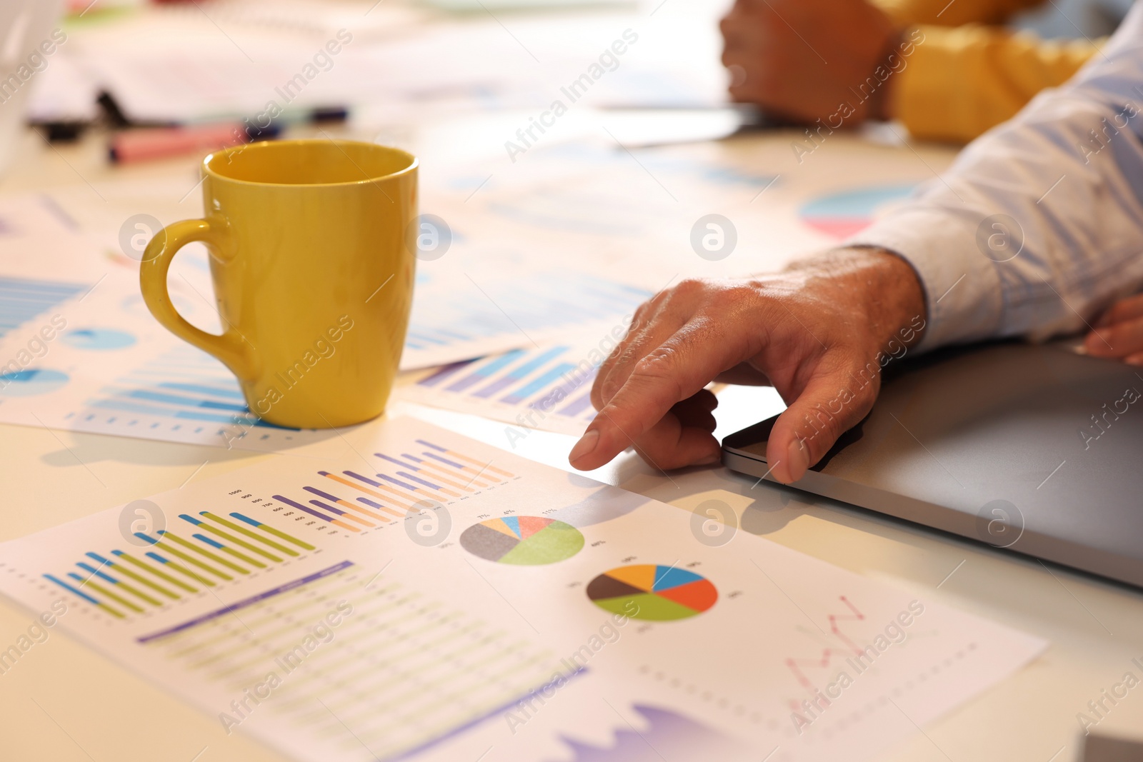 Photo of Man working with charts at table, closeup. Startup project