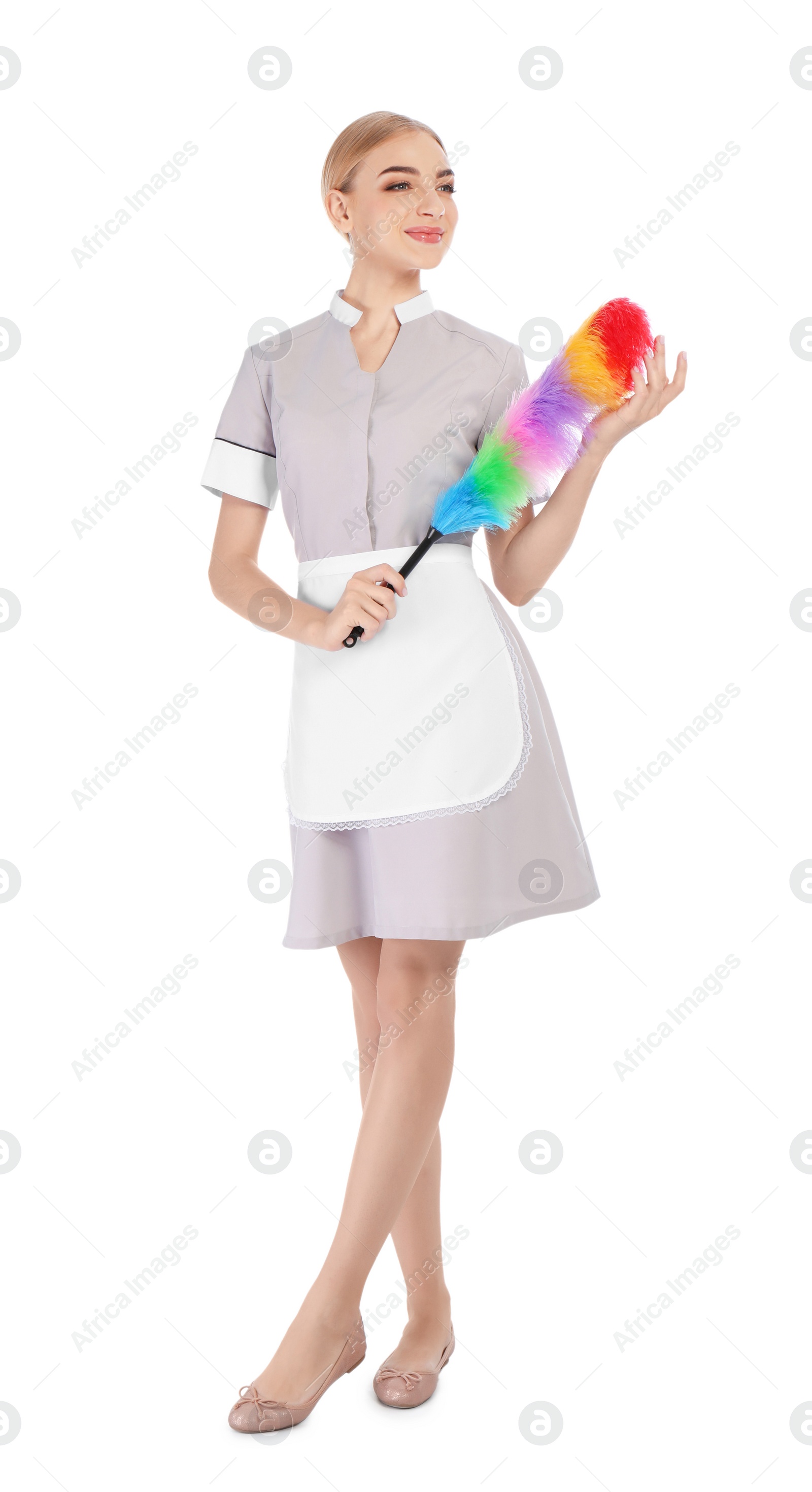 Photo of Young chambermaid with dusting brush on white background