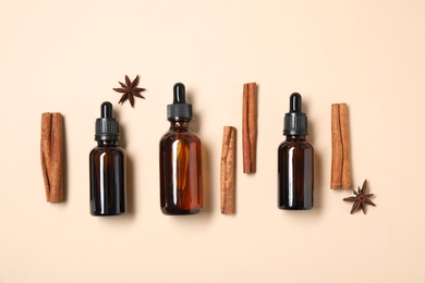 Flat lay composition with cinnamon essential oil on beige background