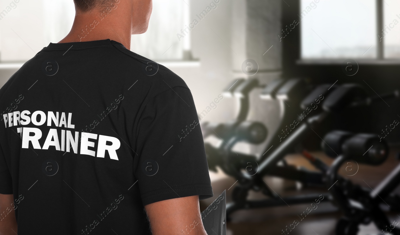 Image of Professional personal trainer in gym. Space for text