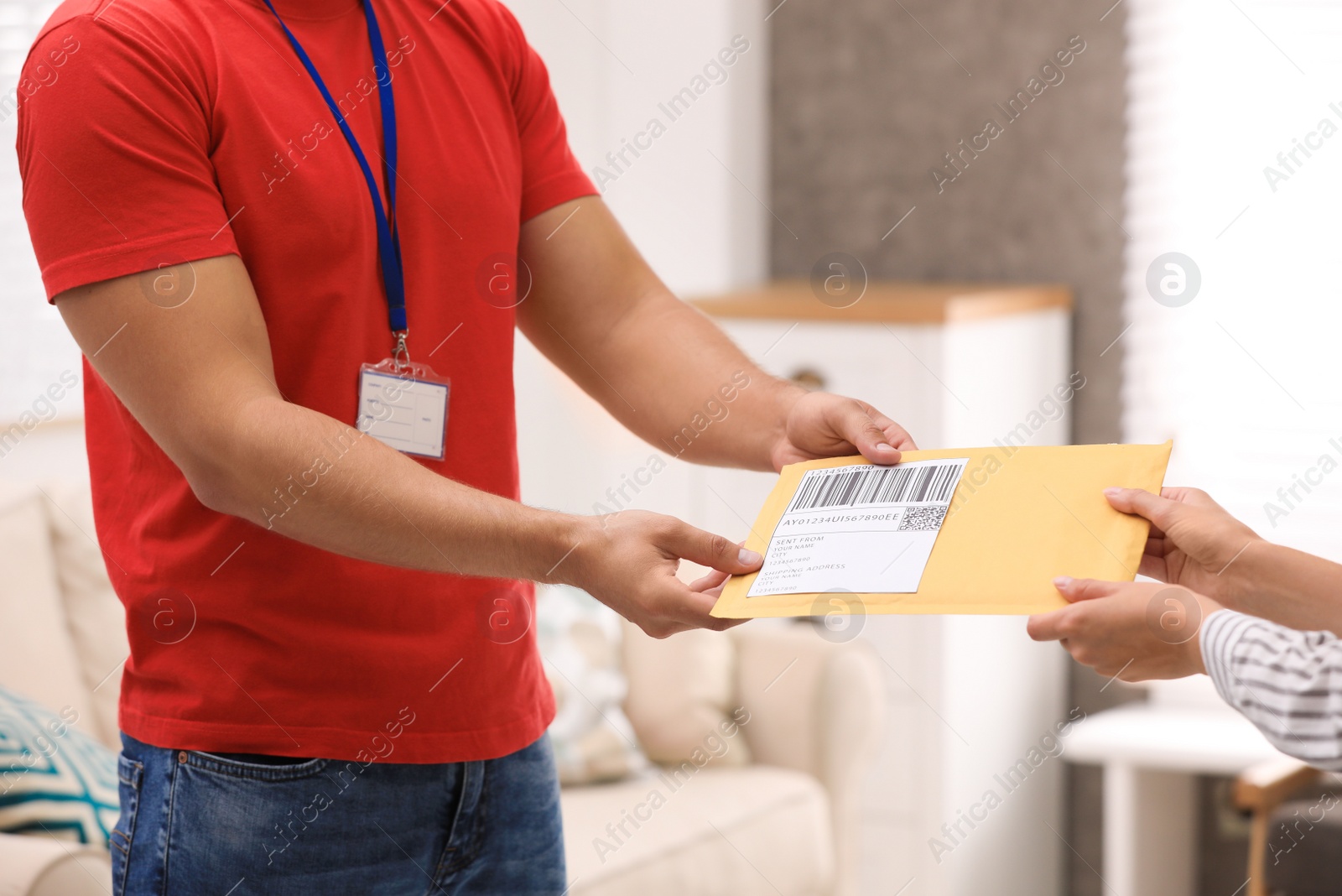 Photo of Woman receiving padded envelope from courier at home, closeup