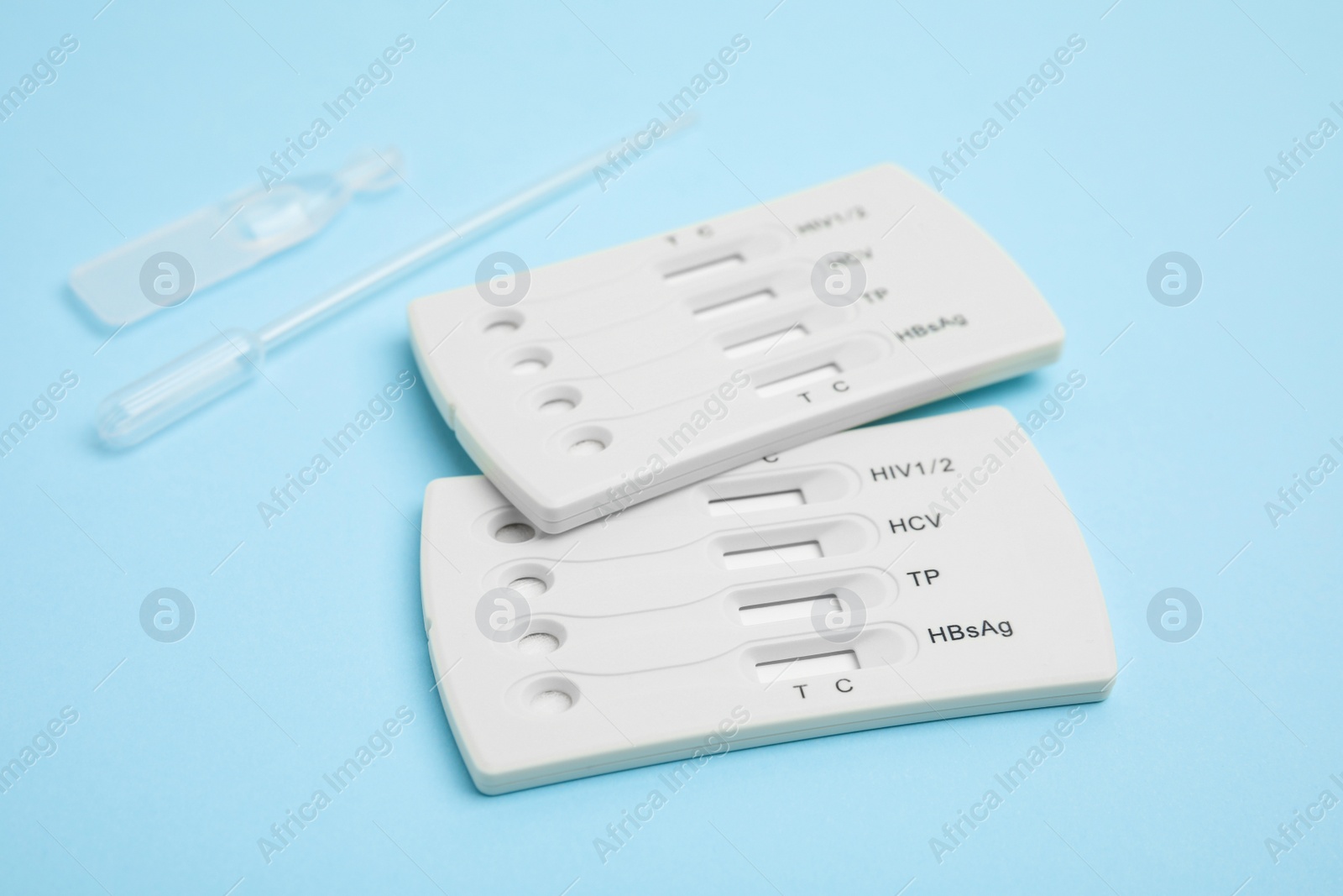 Photo of Disposable express test kit for hepatitis on light blue background