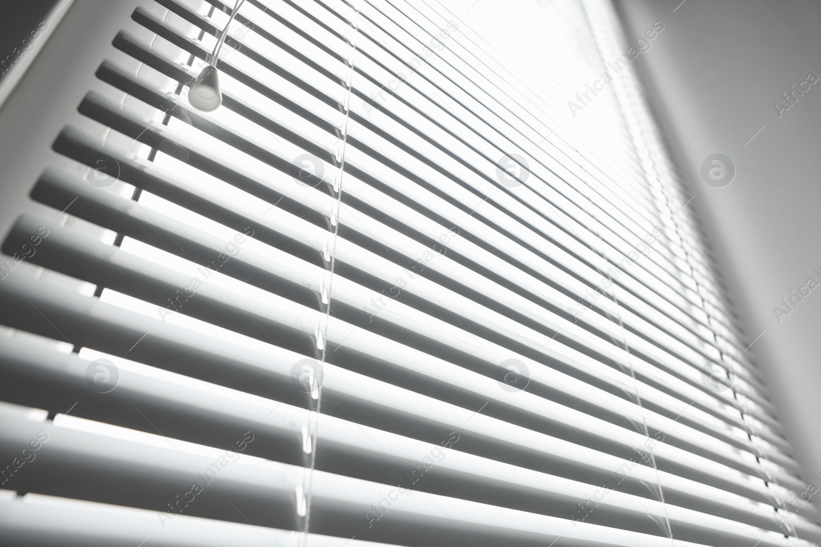 Photo of Stylish horizontal window blinds, low angle view