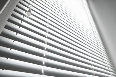 Photo of Stylish horizontal window blinds, low angle view