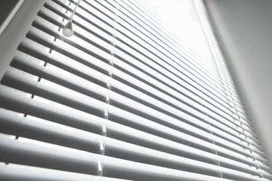 Stylish horizontal window blinds, low angle view