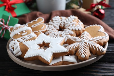 Delicious Christmas cookies on black wooden table table, closeup