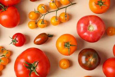 Photo of Flat lay composition with fresh ripe tomatoes on beige background