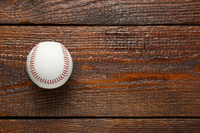 Photo of Baseball ball on wooden table, top view with space for text. Sportive equipment