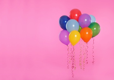 Many bright balloons floating on color background. Space for text