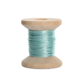 Photo of Wooden spool of turquoise sewing thread isolated on white