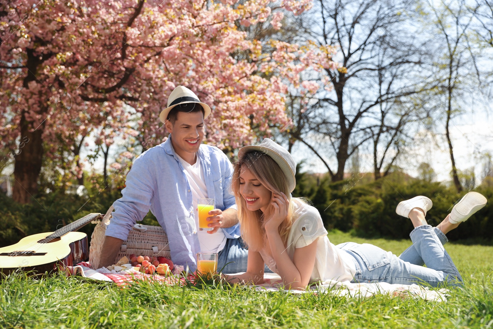 Photo of Happy couple having picnic in park on sunny day