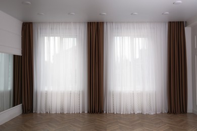 Windows with elegant curtains in room. Interior design