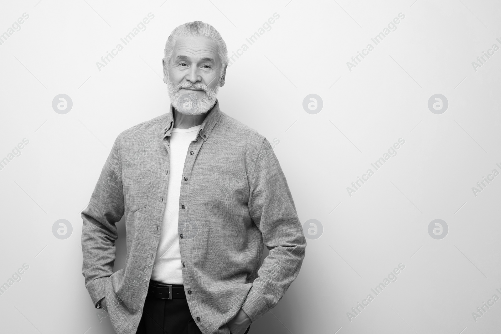 Image of Portrait of handsome senior man on light background, space for text. Black and white effect
