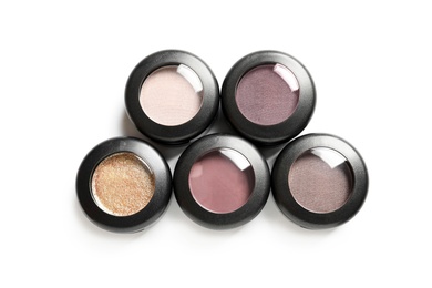 Photo of Different eye shadows on white background, top view. Decorative cosmetics