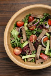 Delicious salad with beef tongue and vegetables on wooden table, top view