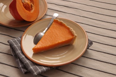 Photo of Plate with piece of fresh homemade pumpkin pie on table