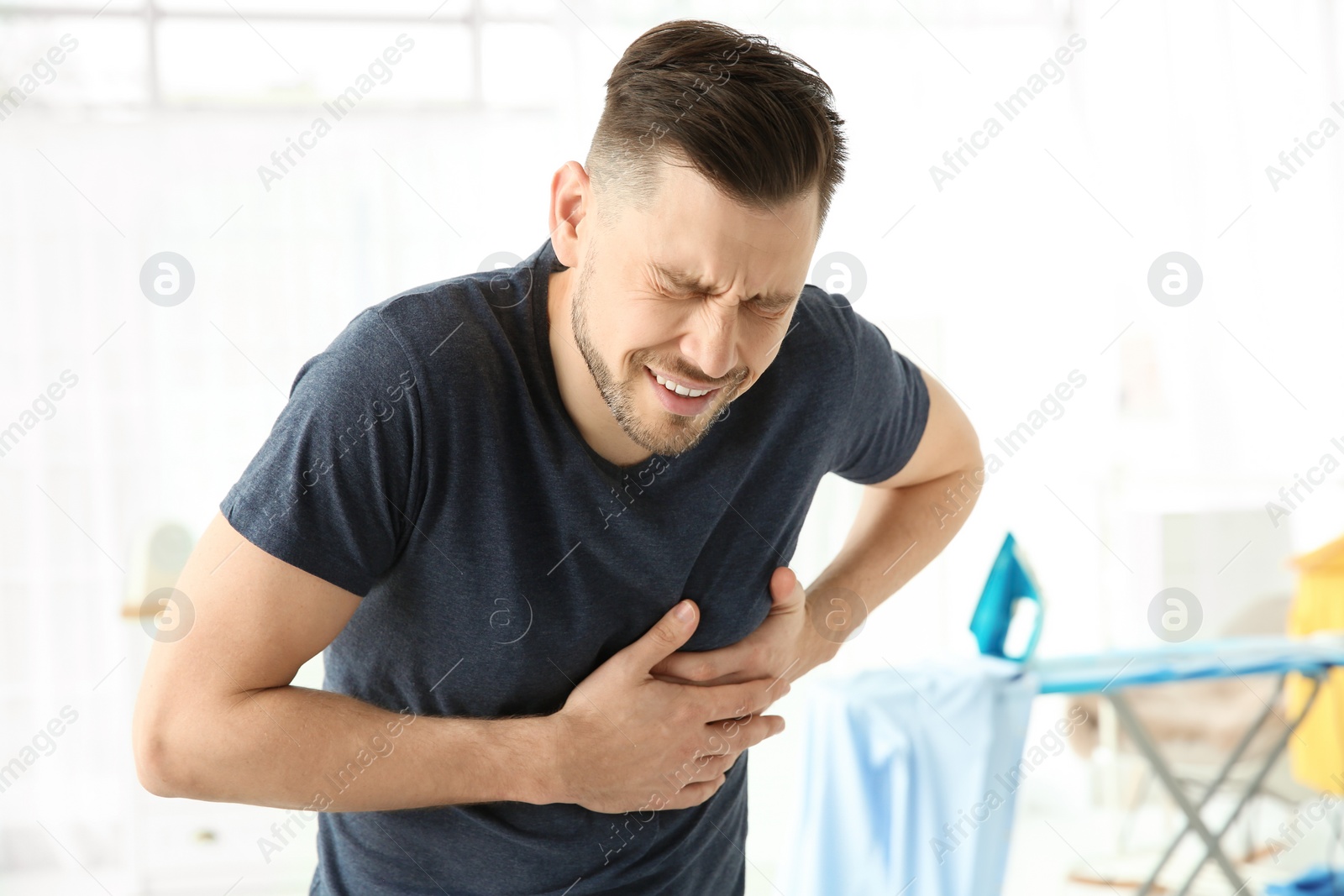 Photo of Mature man suffering from heart attack at home