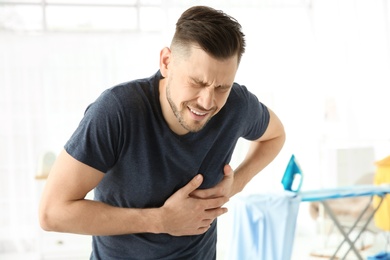 Mature man suffering from heart attack at home