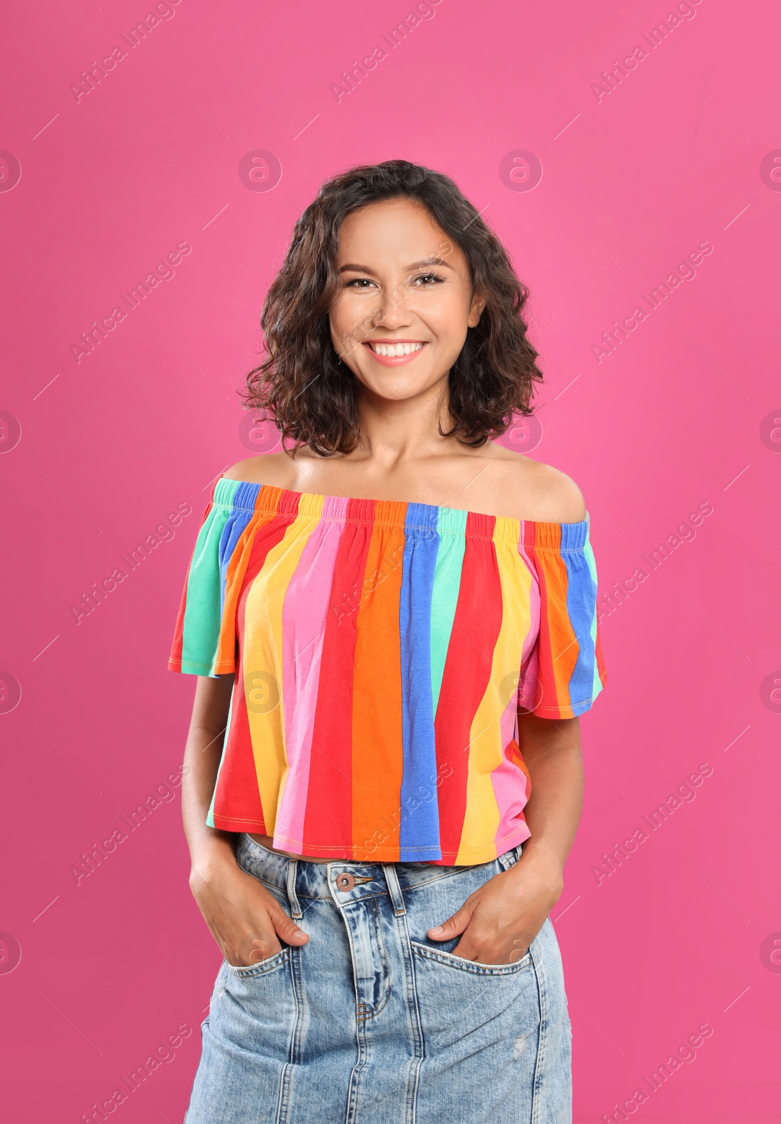 Photo of Happy young woman in casual outfit on pink background